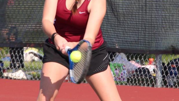 Katie Benson powers a backhand during the doubles tournament on Aug. 24. (Staples World photo by Mark Anderson) Baseline hit