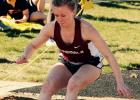 Amber Robben lands in the sand during the long jump. 