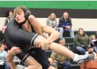 Jonathan Lisson picks up an opponent for a takedown in the triangular meet. He earned two pins that night. (Staples World photo by Mark Anderson)