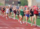 Audrey Brownell, right, runs to the front of the 1,600 meter race and stretches out the pack trying to keep up.