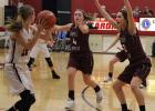 Haley Cichos (4) and Kaila Erbe (2) run at a North Branch player to force her to get rid of the ball quickly. (Staples World photo by Mark Anderson)