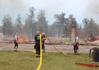 After several hours at the scene of a controlled burn at the Motley Motel April 29, Motley firefighters worked to put all of their equipment and gear away. Pictured above in front of the last remaining remnants of the motel are, from left, Lonna Dille, Jim Uhlman, Chief Todd Judd; and Nick Dille, 2nd Asst. Chief. (Staples World photo by Dawn Timbs)