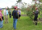 CLC specialty foods instructor Thaddeus McCamant, far right, showed one of the many varieties of apples at the 2017 Field Day.