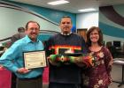 Ken Means, center, shows his graduation blanket and eagle feather with Bryan Tollefson and Sandy Opheim of the Freshwater Education District. (Submitted photo)